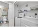 Convenient laundry area with washer, dryer, and storage shelves at 5300 S Atlantic Ave # 16-205, New Smyrna Beach, FL 32169
