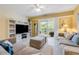 Inviting living room with comfortable seating, TV, and balcony access, offering relaxing views at 5300 S Atlantic Ave # 16-205, New Smyrna Beach, FL 32169
