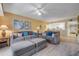 Open-concept living area featuring comfortable seating, stylish decor, and a view of the modern kitchen at 5300 S Atlantic Ave # 16-205, New Smyrna Beach, FL 32169