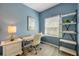 Office with desk, chair, shelving, and serene natural light at 5300 S Atlantic Ave # 16-205, New Smyrna Beach, FL 32169