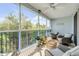 Welcoming screened porch with ceiling fan, comfortable seating, and scenic views at 5300 S Atlantic Ave # 16-205, New Smyrna Beach, FL 32169