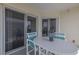 Cozy outdoor balcony with a table, chairs, and sliding glass doors for seamless indoor-outdoor living at 5300 S Atlantic Ave # 20-507, New Smyrna Beach, FL 32169