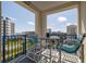 Enjoy beautiful city views from the cozy outdoor balcony with seating for two at 5300 S Atlantic Ave # 20-507, New Smyrna Beach, FL 32169