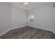Neutral bedroom with dark wood-look floors, a ceiling fan, and a window at 5300 S Atlantic Ave # 20-507, New Smyrna Beach, FL 32169
