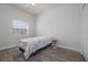 Simple bedroom features a single bed, ceiling fan and dark wood-look floors at 5300 S Atlantic Ave # 20-507, New Smyrna Beach, FL 32169