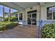 Welcoming TEC Bldg entrance with glass doors, steps, blue railings, and lush landscaping, providing easy access and curb appeal at 5300 S Atlantic Ave # 20-507, New Smyrna Beach, FL 32169