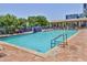 Large community pool featuring a waterfall, poolside seating, and lush landscaping, creating a serene and inviting oasis at 5300 S Atlantic Ave # 20-507, New Smyrna Beach, FL 32169