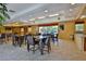 Spacious common room with tables, chairs, fireplace, television and access to the pool area at 5300 S Atlantic Ave # 20-507, New Smyrna Beach, FL 32169