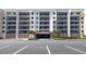 Condo building featuring large balconies with parking garage and landscaped entryway for a welcoming feel at 5300 S Atlantic Ave # 20-507, New Smyrna Beach, FL 32169