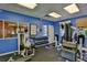 Community gym with weight machines, free weights, and a window to another room at 5300 S Atlantic Ave # 20-507, New Smyrna Beach, FL 32169