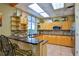 This open kitchen features wood cabinets, granite countertops, stainless steel appliances, and tile backsplash at 5300 S Atlantic Ave # 20-507, New Smyrna Beach, FL 32169