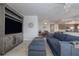 Comfortable living room with media center, tile flooring, and a view into the kitchen and dining area at 5300 S Atlantic Ave # 20-507, New Smyrna Beach, FL 32169