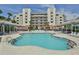 Relaxing pool area with shaded cabanas, lounge chairs, and beautiful landscaping, perfect for outdoor enjoyment at 5300 S Atlantic Ave # 20-507, New Smyrna Beach, FL 32169