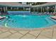 Large community pool surrounded by seating and a covered patio at 5300 S Atlantic Ave # 20-507, New Smyrna Beach, FL 32169