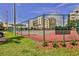 Outdoor tennis court with net and view of the building at 5300 S Atlantic Ave # 20-507, New Smyrna Beach, FL 32169