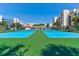 View of tennis courts with buildings of the surrounding condominium community at 5300 S Atlantic Ave # 20-507, New Smyrna Beach, FL 32169