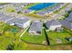 Beautiful aerial view of the home with a spacious backyard, fire pit, and screened-in pool in a great community at 5607 Estero Loop, Port Orange, FL 32128