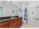 Full bathroom features granite counters, dark wood cabinets, and shower-tub combo at 5607 Estero Loop, Port Orange, FL 32128
