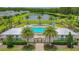 Aerial view of the Westport community pool and clubhouse with palm trees and a view of the lake at 5607 Estero Loop, Port Orange, FL 32128