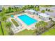 Aerial view of the Westport community pool featuring lounge chairs, umbrellas, and nearby community buildings at 5607 Estero Loop, Port Orange, FL 32128