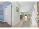 Bright entryway with tile flooring, coat rack, and view into the open-concept living area at 5607 Estero Loop, Port Orange, FL 32128