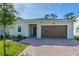 Inviting home with a two-car garage and a well-maintained front yard with flower beds at 5607 Estero Loop, Port Orange, FL 32128
