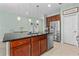 Kitchen island with granite top, stainless steel dishwasher and adjacent dining area at 5607 Estero Loop, Port Orange, FL 32128