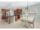 Open-concept kitchen with central island, adjacent dining area, and stainless steel appliances at 5607 Estero Loop, Port Orange, FL 32128