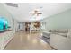Expansive living room flowing to kitchen, featuring tiled floors, modern decor, and abundant natural light at 5607 Estero Loop, Port Orange, FL 32128