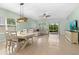 Living and dining area featuring tile floors, a ceiling fan and natural light at 5607 Estero Loop, Port Orange, FL 32128