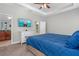 Relaxing main bedroom with soft carpet, ensuite bath, neutral paint, ceiling fan, closet and TV at 5607 Estero Loop, Port Orange, FL 32128