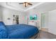 Comfortable main bedroom with carpet, ceiling fan, en-suite bathroom, closet and TV at 5607 Estero Loop, Port Orange, FL 32128