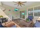 Enclosed patio offers brick pavers, ceiling fan, and TV, creating a comfortable space for entertaining or relaxation at 5607 Estero Loop, Port Orange, FL 32128