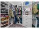Organized walk-in closet boasts custom shelving, multiple hanging rods, and storage drawers for optimal space utilization at 5607 Estero Loop, Port Orange, FL 32128