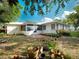 Backyard with a garden, and brick patio offering a serene outdoor space at 600 Magnolia St, New Smyrna Beach, FL 32168