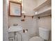 Cozy bathroom featuring white brick walls, wooden fixtures, and a shower with classic curtain at 600 Magnolia St, New Smyrna Beach, FL 32168