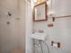 Cozy bathroom featuring a shower, sink, and charming wooden fixtures on painted brick walls at 600 Magnolia St, New Smyrna Beach, FL 32168