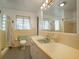 Charming bathroom featuring colorful tile, a large mirror, and a shower with unique curtain at 600 Magnolia St, New Smyrna Beach, FL 32168