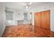 Bright bedroom showcasing wood floors, a built-in desk, and large windows offering natural light at 600 Magnolia St, New Smyrna Beach, FL 32168