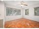 Bright bedroom featuring hardwood floors, large windows offering natural light and ceiling fan at 600 Magnolia St, New Smyrna Beach, FL 32168