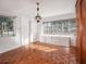 Well-lit bedroom featuring wood floors, white walls, built-in drawers, and a large sunny window at 600 Magnolia St, New Smyrna Beach, FL 32168