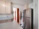 The kitchen features stainless steel refrigerator, and tan cabinetry at 600 Magnolia St, New Smyrna Beach, FL 32168
