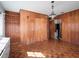 Living room featuring wood paneled walls, parquet flooring and vintage light fixture at 600 Magnolia St, New Smyrna Beach, FL 32168