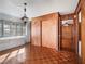 Living room features wood paneled walls, parquet flooring, built in shelves and vintage light fixture at 600 Magnolia St, New Smyrna Beach, FL 32168