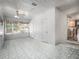 Enclosed sunroom with tiled floors, bright natural light, and access to the kitchen area at 600 Magnolia St, New Smyrna Beach, FL 32168