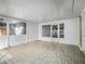 Bright sunroom with tile flooring, white brick walls and lots of windows for natural lighting at 600 Magnolia St, New Smyrna Beach, FL 32168