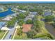 Aerial view of a lovely neighborhood with lake views, mature landscaping, and a vibrant sense of community at 6093 Sabal Creek Blvd, Port Orange, FL 32128