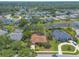 Expansive aerial view of a residential community featuring beautiful homes and a serene lake, surrounded by lush greenery and mature trees at 6093 Sabal Creek Blvd, Port Orange, FL 32128