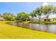 Water view from the backyard, showcasing well-maintained lawn and beautiful greenery at 6093 Sabal Creek Blvd, Port Orange, FL 32128