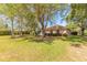 Expansive backyard with mature trees and landscaped surroundings at 6093 Sabal Creek Blvd, Port Orange, FL 32128